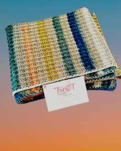 Foulard multicolore tricoté présenté à côté d'une carte de visite.
